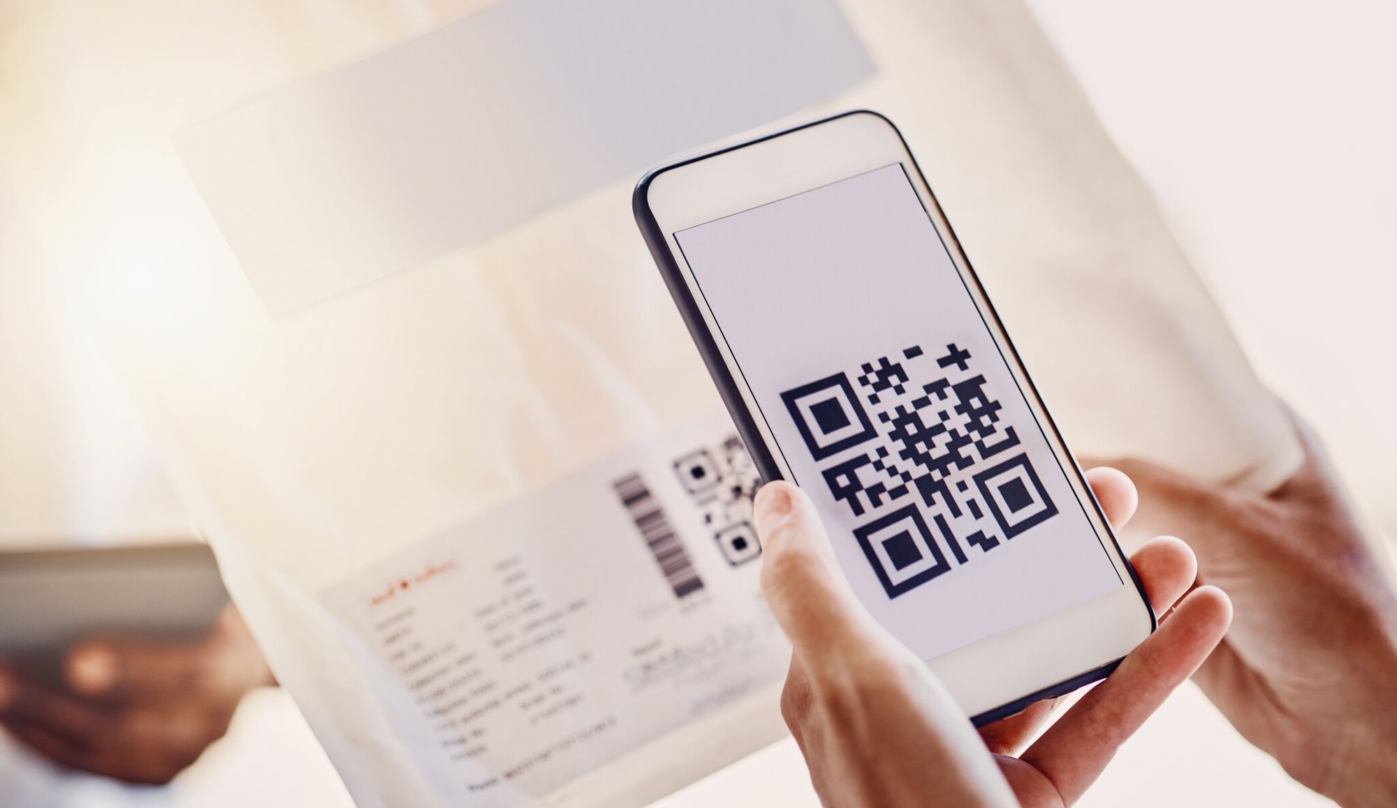 Smartphone scanning a QR code on a delivery receipt to confirm an online order