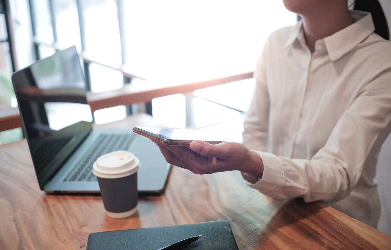 Woman scanning a QR code on a receipt to complete a contactless payment
