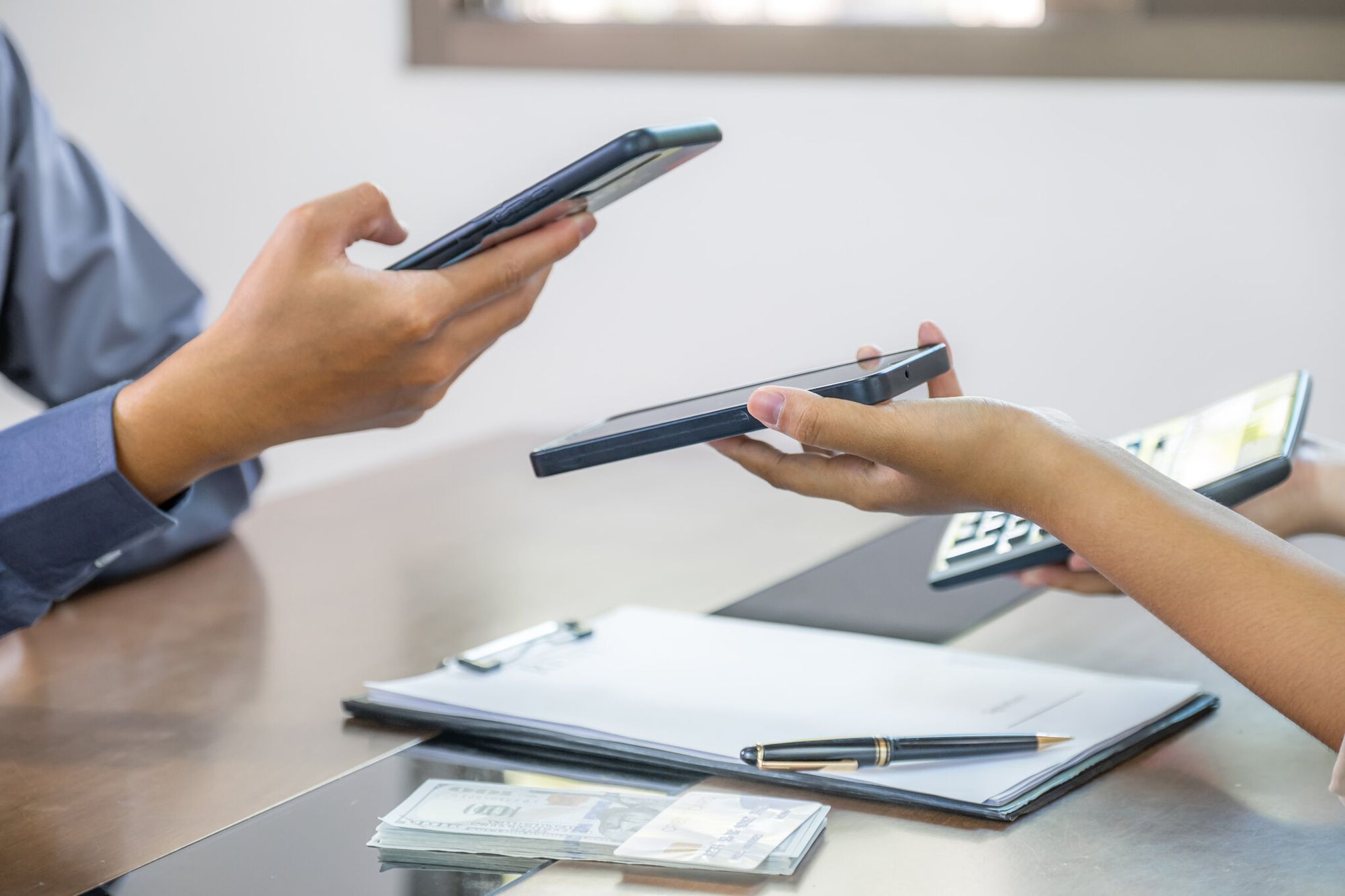 A hand scanning a QR code for instant document payment verification
