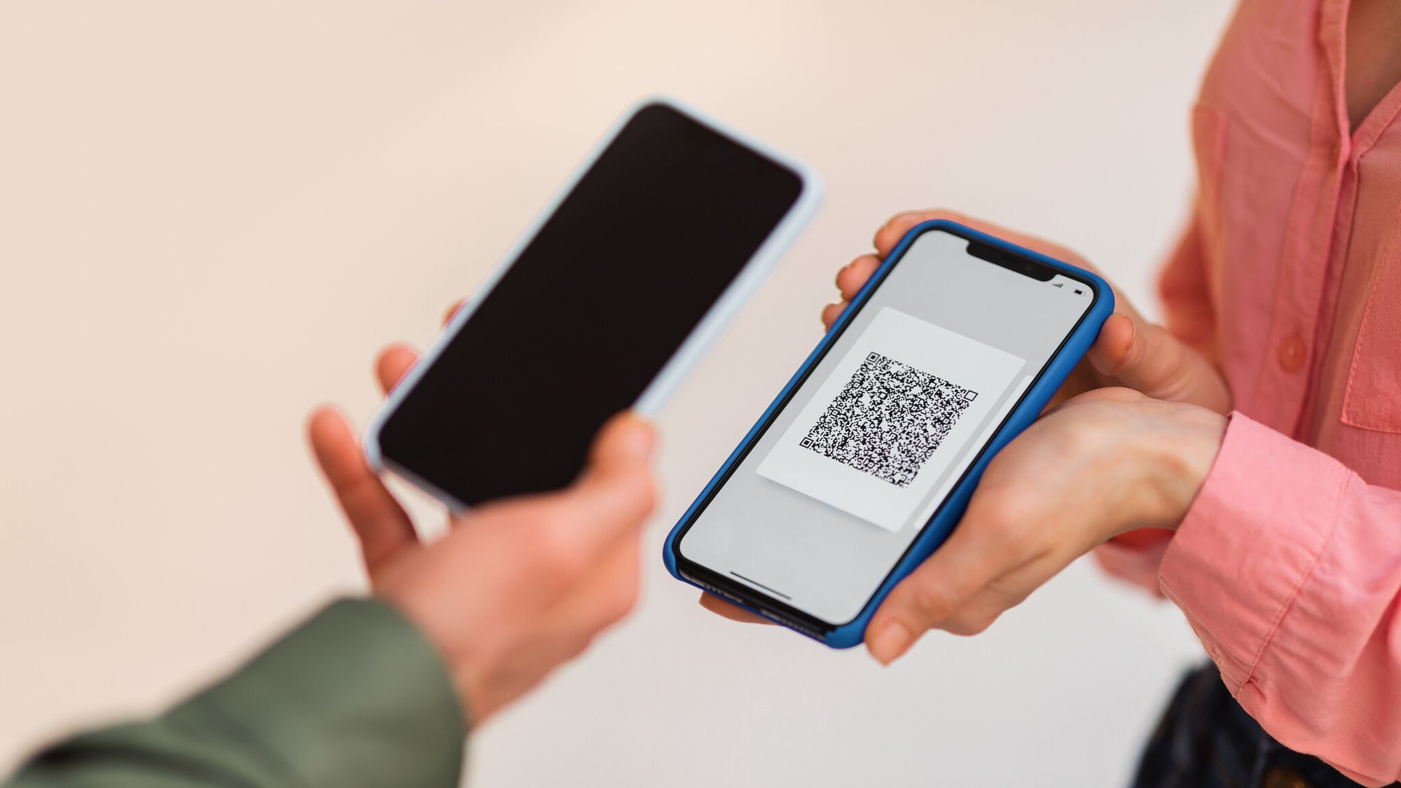 Teacher scanning a classroom QR code on a smartphone to demonstrate safe scanning habits