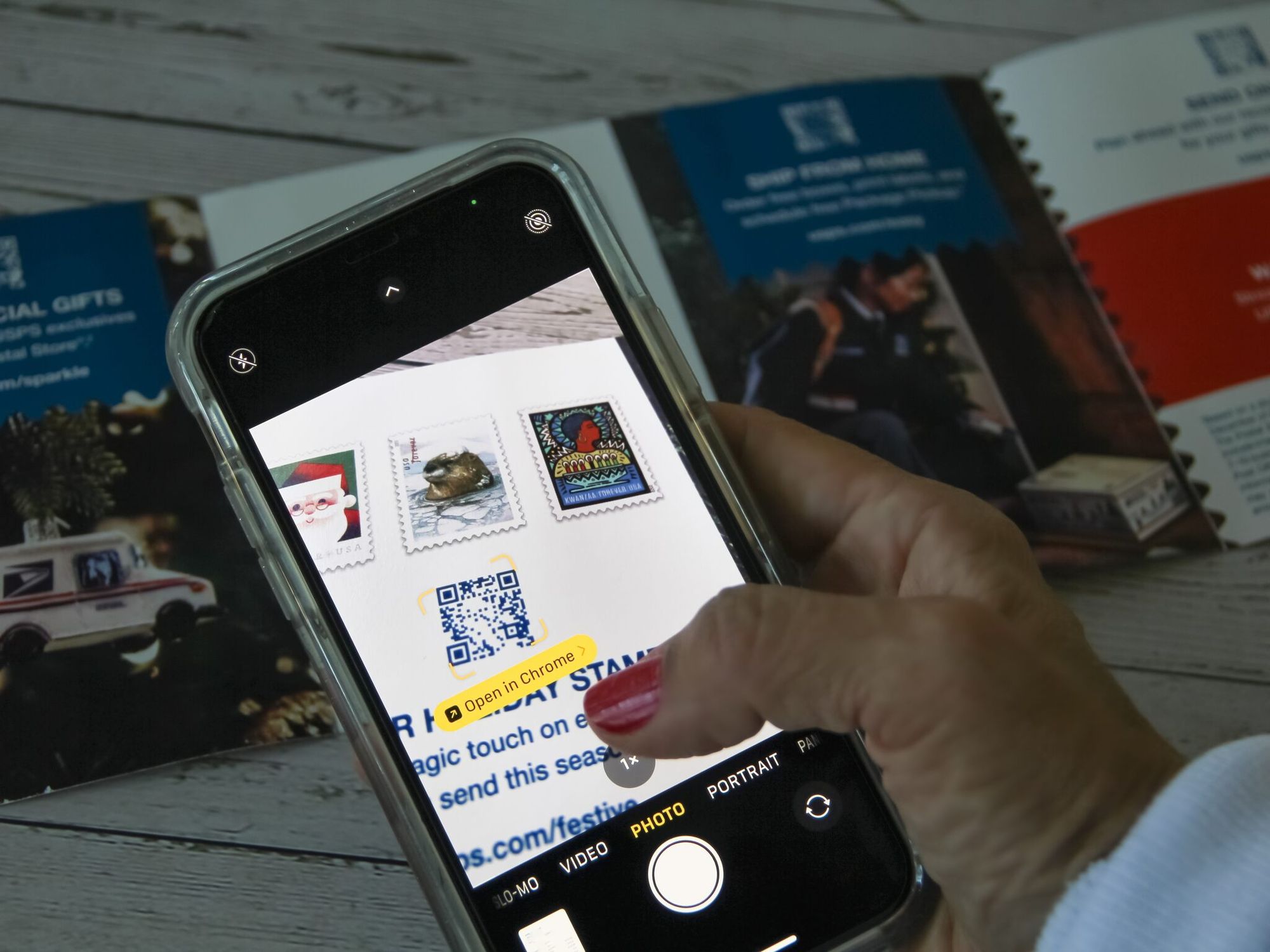 woman scanning a postcard QR code with an iPhone camera