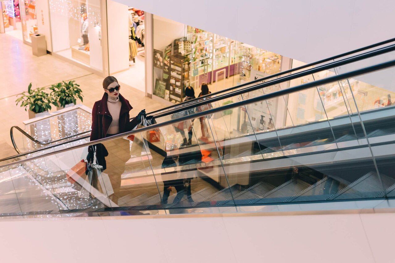 a woman in a shopping mall with shopping bags