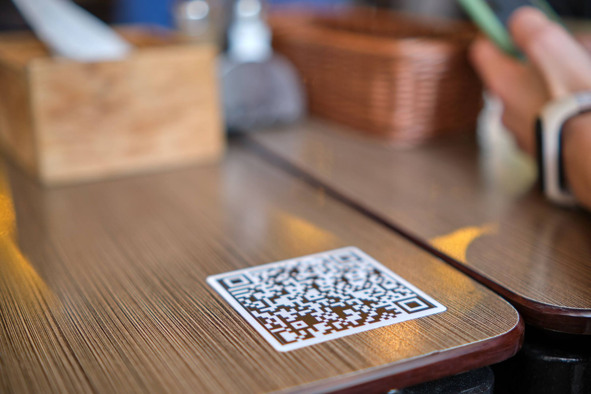 closeup of guest hand ordering meal in restaurant