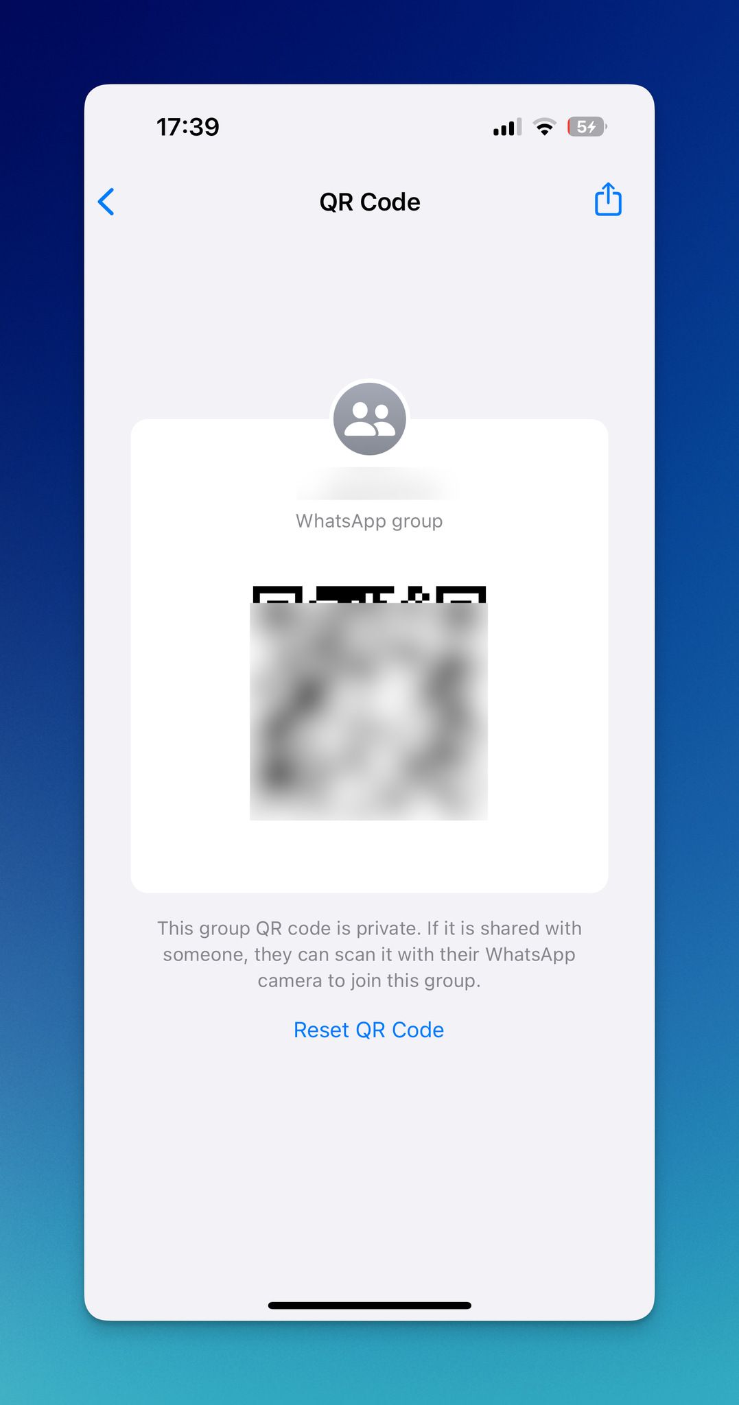 WhatsApp group QR code displayed on phone with share and reset options below it