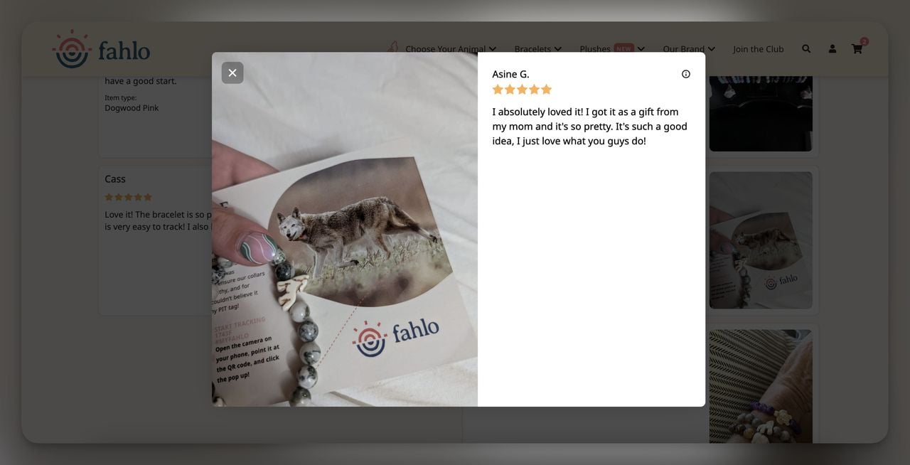 User-submitted review photo showing a Fahlo bracelet alongside an animal tracking card with a QR code, expressing satisfaction with the product.